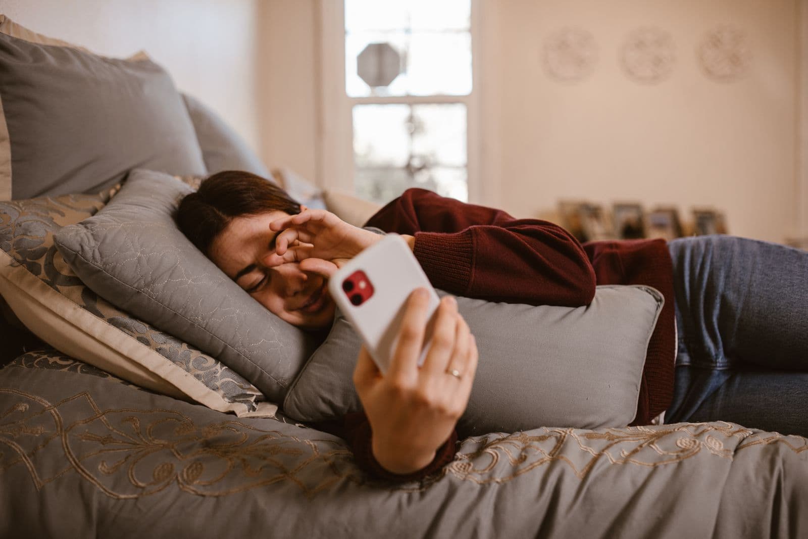 Person lying in bed reading on a phone