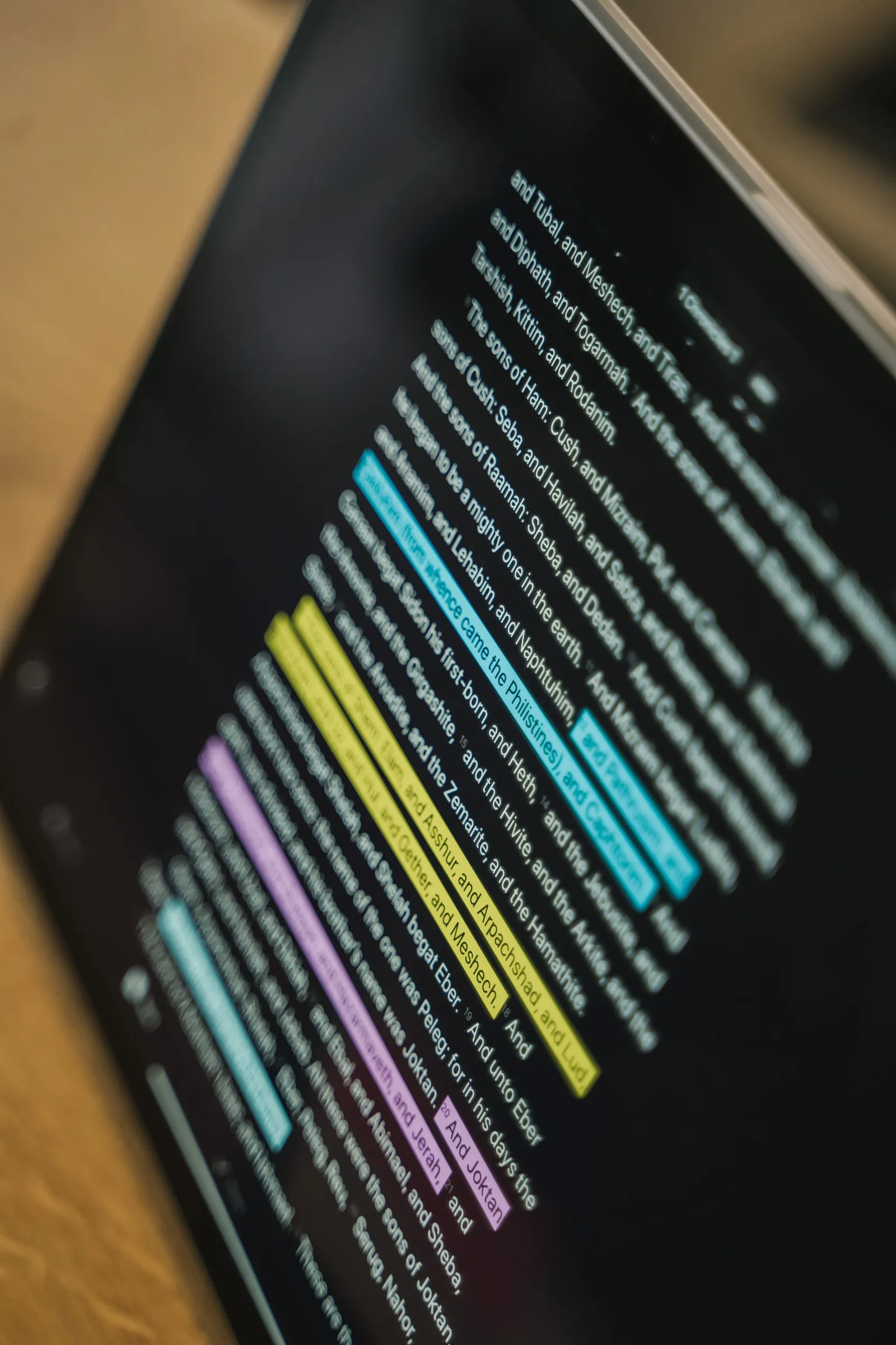 A tablet screen showing an English text with color-highlighted passages.