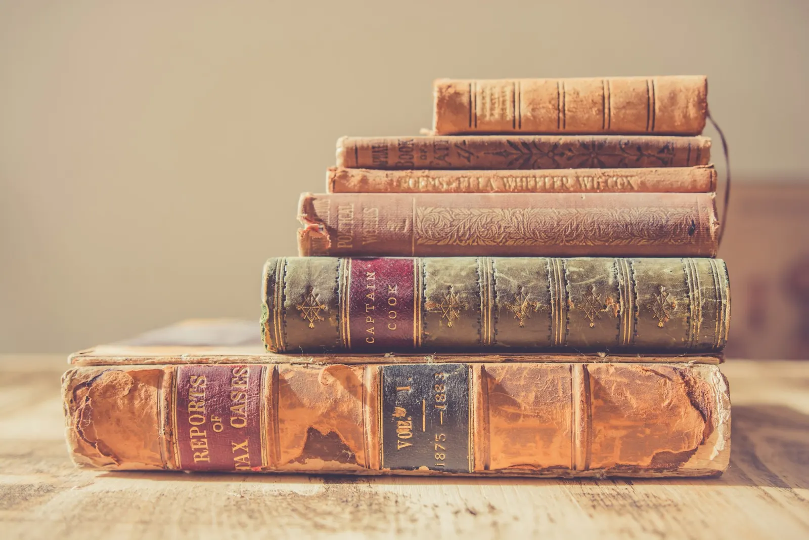 A stack of open old books piled on top of each other.