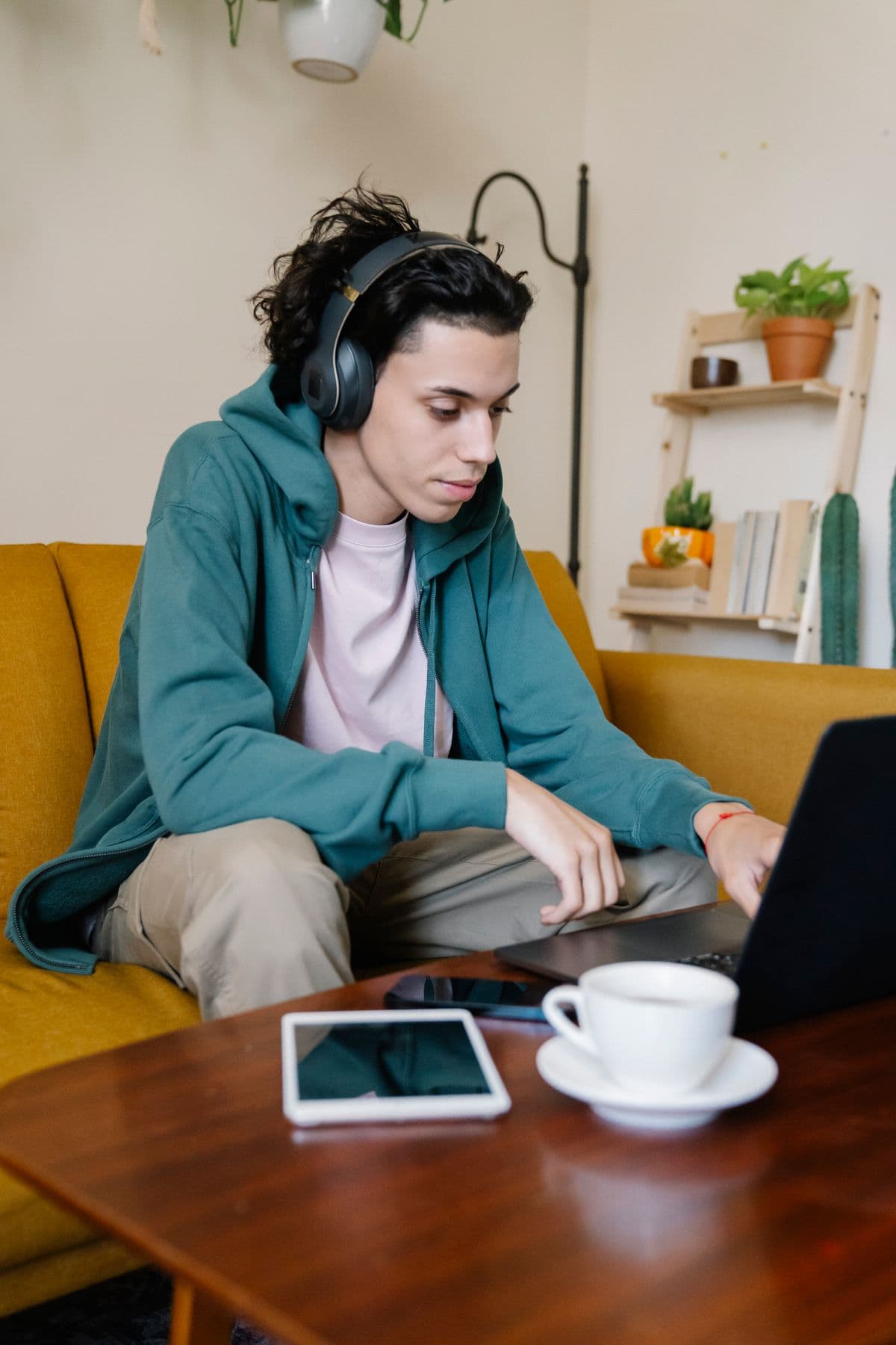Person wearing headphones, following a lesson on their laptop