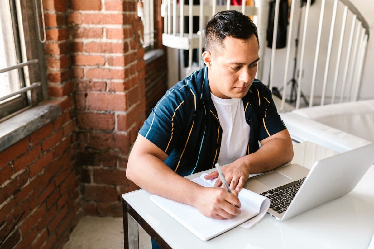 Person studying focused on their laptop at home