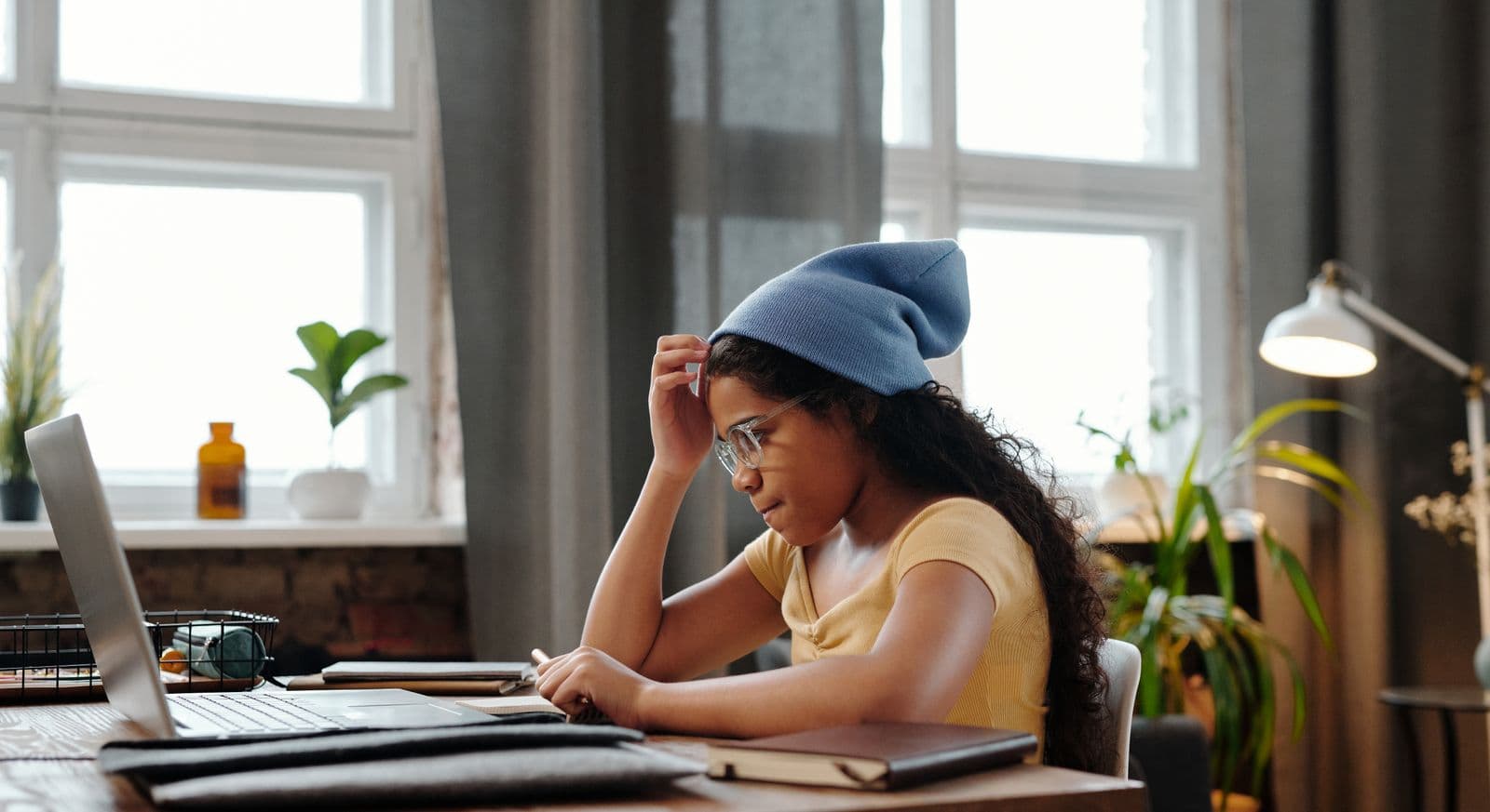 Adolescente lisant à son bureau à la maison