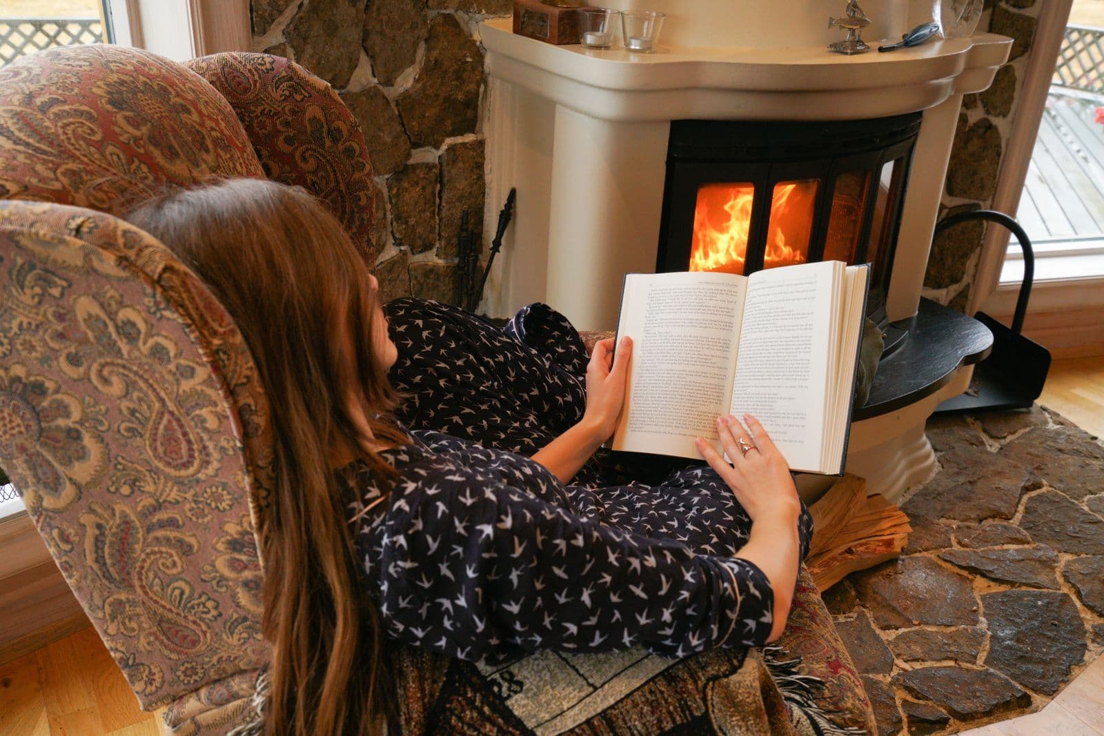 Woman reading in an armchair, calm mood
